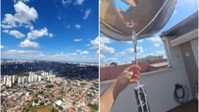 Estudante Pedro Augusto segurando balões de hélio com celular amarrado.