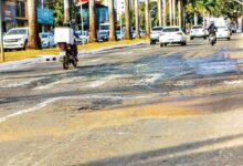 Avenida T-63 em Goiânia mostrando asfalto deteriorado.