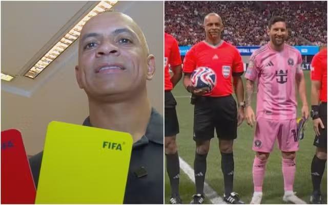 Árbitro brasileiro em ação durante uma partida de futebol.