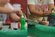 Mulher filmada colocando substância em garrafa de água.