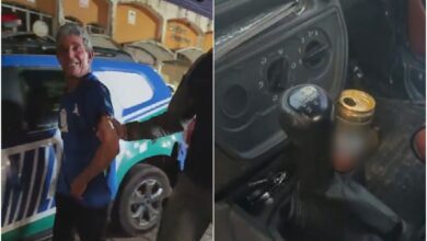 Motorista sorrindo enquanto é preso por embriaguez ao volante.