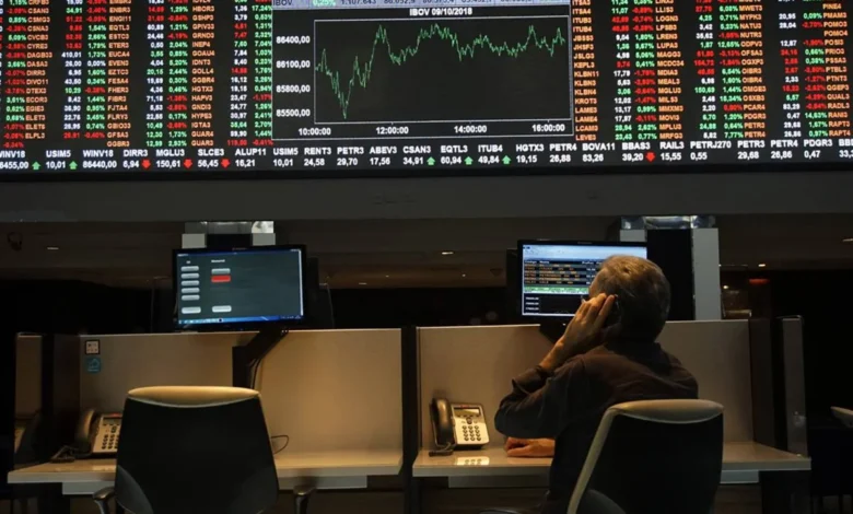 Bolsa de Valores durante pregão com gráficos de ações em queda.